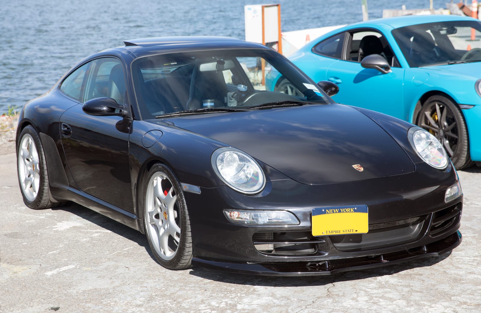 Black 2007 Porsche 911 Carrera coupe of the 997 generation, front three-quarter view